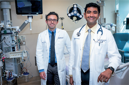 Drs. Mehdiratta (left) and Krishnamoorthy in the SICU at Duke University Hospital.