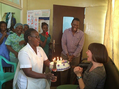 Dr. Kayla Bryan being presented a birthday cake.