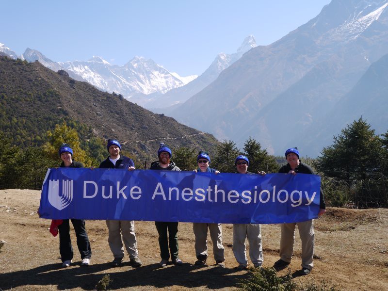 Left to right Anna Grodecki, Peter Moon, Nelson Diamond (Duke medical student), Richard Moon, Chris Young and Gene Moretti. In the background can be seen Everest (2nd peak from the left), Lhotse and Amadablam.