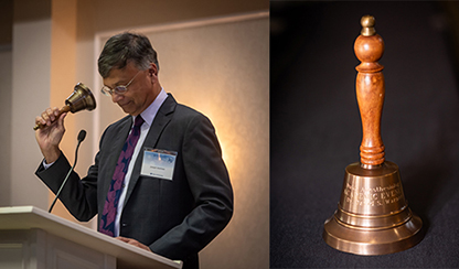 Dr. Mathew ringing Dr. Warner's bell at the 30th Anniversary Academic Evening