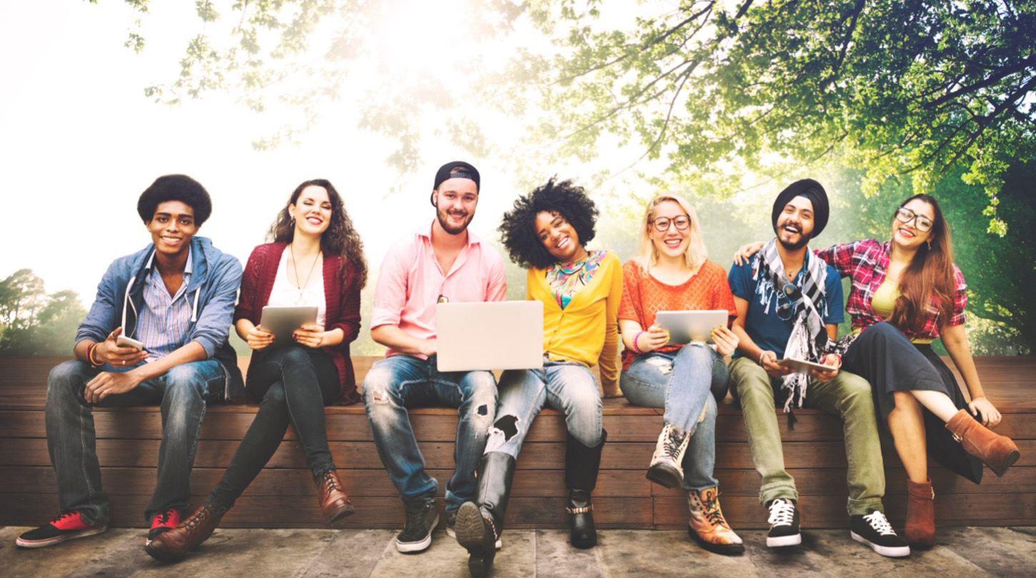 Group of people hanging out with laptops and tablets.