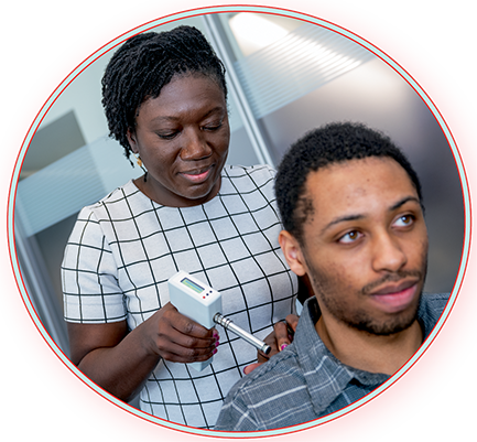 Dr. Kenney and a research assistant demonstrating the use of an algometer to determine pain thresholds for pressure application in soft tissue, muscles and joints.