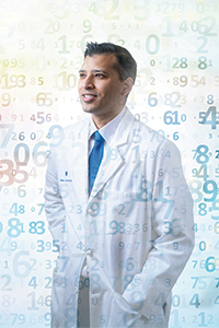 Dr. Ray standing in front of an abstract background of numbers
