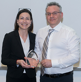 Dr. Andrea Nackley receiving her award from Dr. Seth Weinburg, Associate Dean for Research at the Adams School of Dentristy.