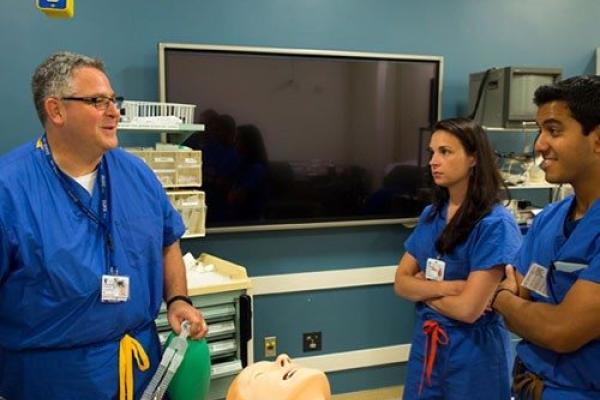Dr. Taekman with students in the Simulation lab