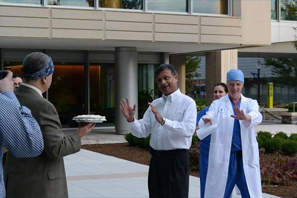 Dr. Mathew about to receive a pie in the face to help support Global Health