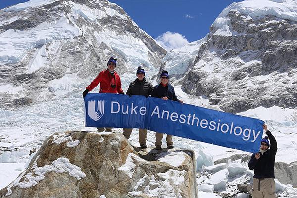 Everest Base Camp with Drs. Chris Young, Gene Moretti, Richard Moon, and Peter Moon on far right.