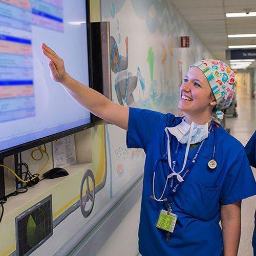 Anesthesiology Fellow looking at procedure board.