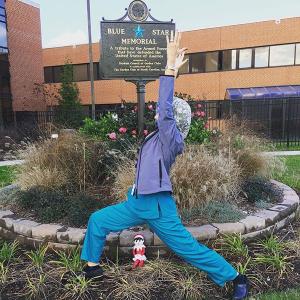 Dr. Dana Wiener is seen here doing warrior pose outside of the Durham VA Medical Center Blue Star Memorial.